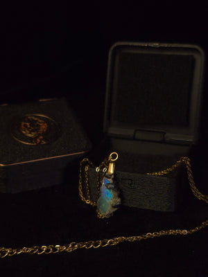Raw uncut Ethiopian Welo opal pendant. Colour: blue and green, strong. Body: deep blue. Shown with its open gift box.