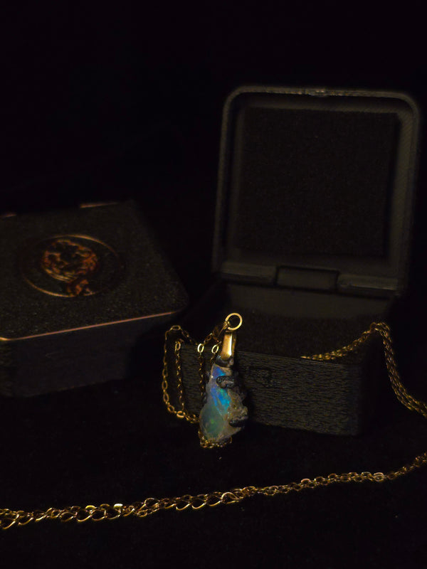 Raw uncut Ethiopian Welo opal pendant. Colour: blue and green, strong. Body: deep blue. Shown with its open gift box.